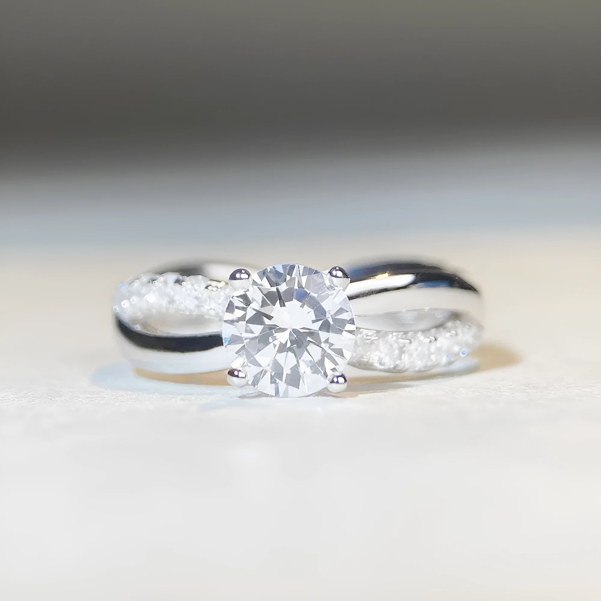 Silver moissanite ring with 1 karat stone and cross twisted arm geometric design