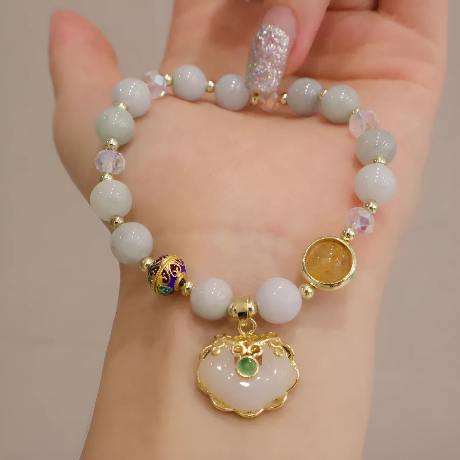 Geometric women's bracelet in gray jade and strawberry quartz with metal ethnic decoration