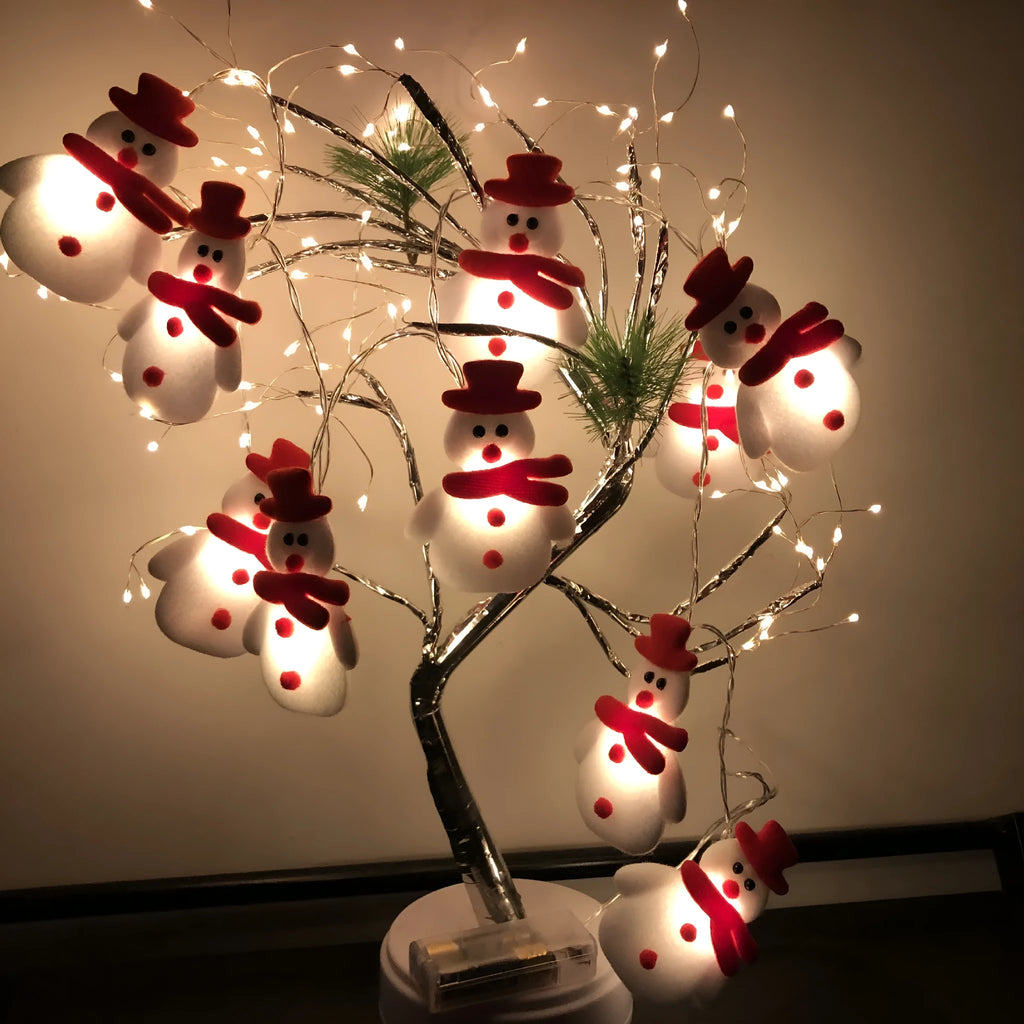 Snowman LED string lights garland with warm white glow on a Christmas tree