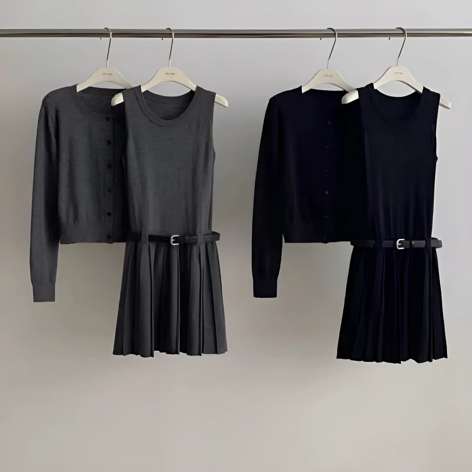 Grey and black women's knitted vest skirt and long-sleeved cardigan two-piece set with a belt.