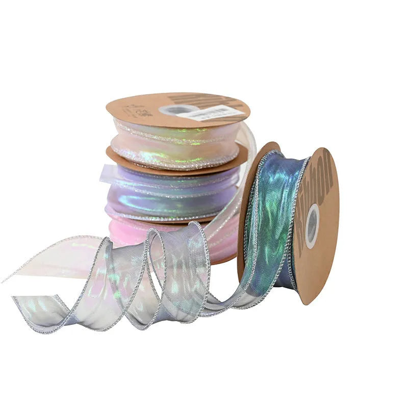 Fishtail yarn mesh ribbon roll in various illusion colours showing wave pattern and 4cm width