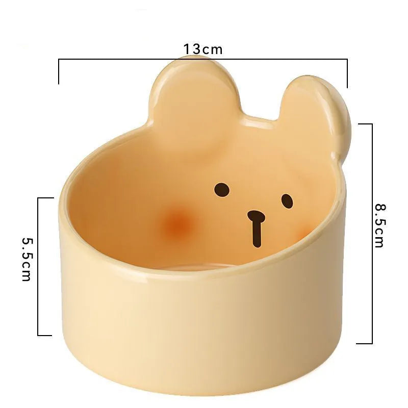 White ceramic pet food bowl with slant design on a plain surface