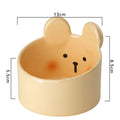 White ceramic pet food bowl with slant design on a plain surface