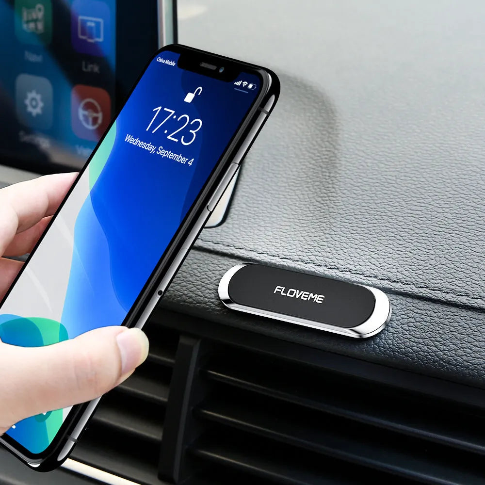 Black magnetic car and home mobile phone holder with silver iron sheet and white foam glue.