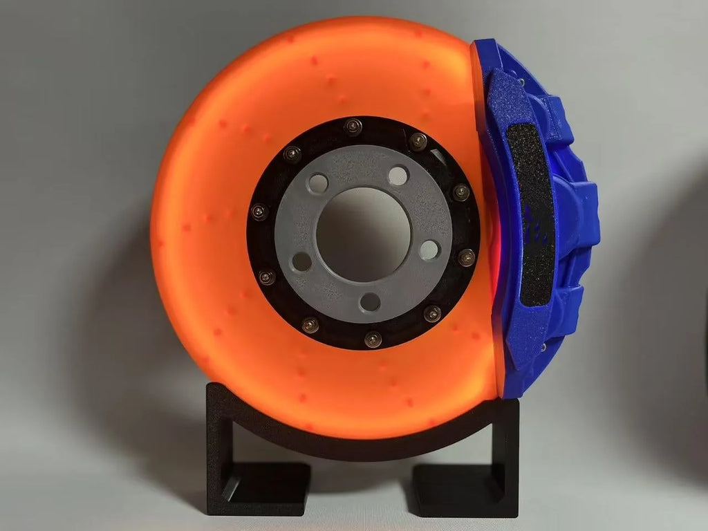 Rechargeable brake disc LED night light with touch dimmer, blue caliper colour, on a desk