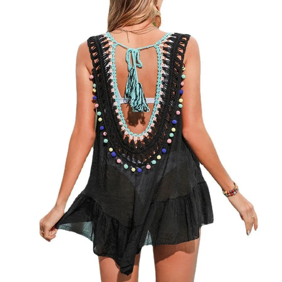 Black hand-crocheted women's beach cover-up vest with ruffled cut-out design on a hanger