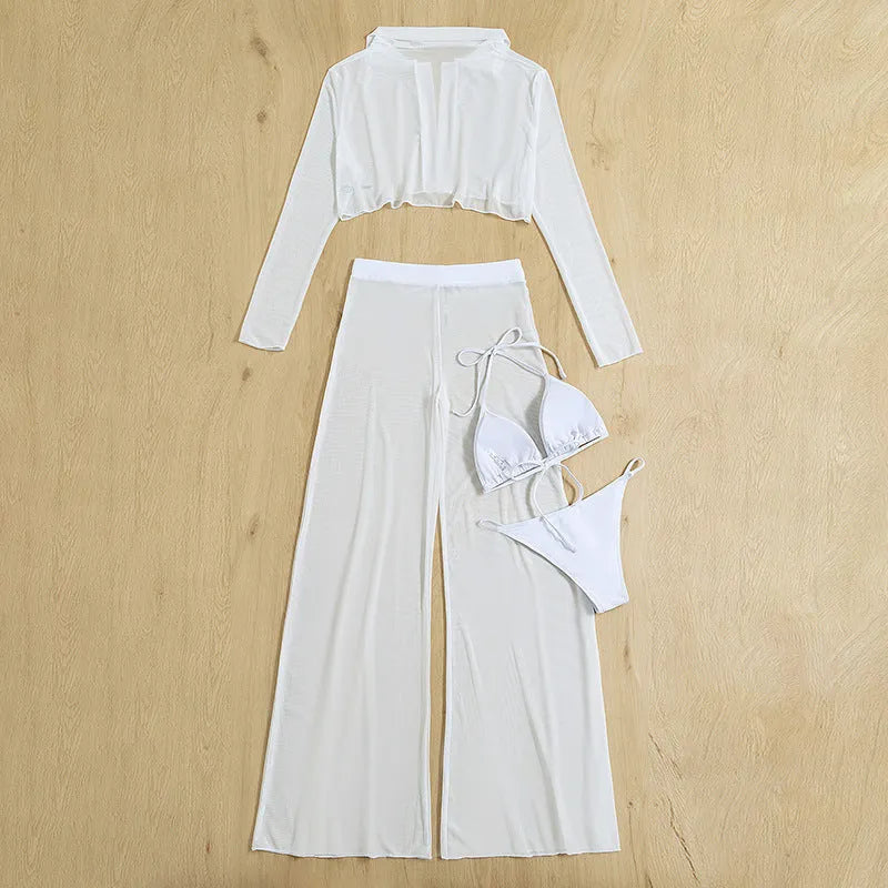 Women's white four-piece swimsuit set with high waist bottoms and backless top on a beach background