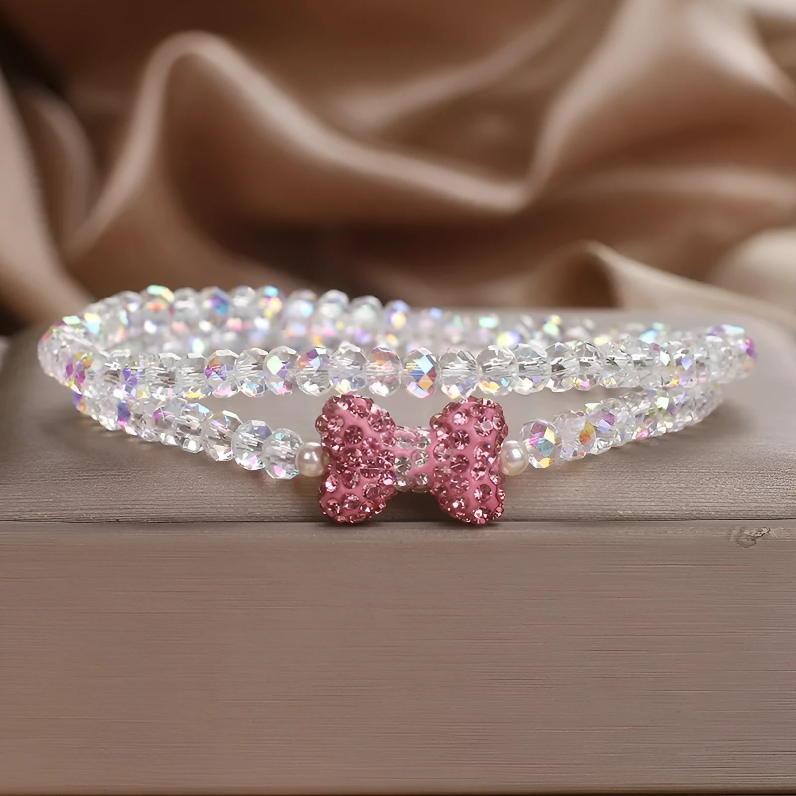 Double ring crystal bracelet with pearl and rhinestone accents on light background