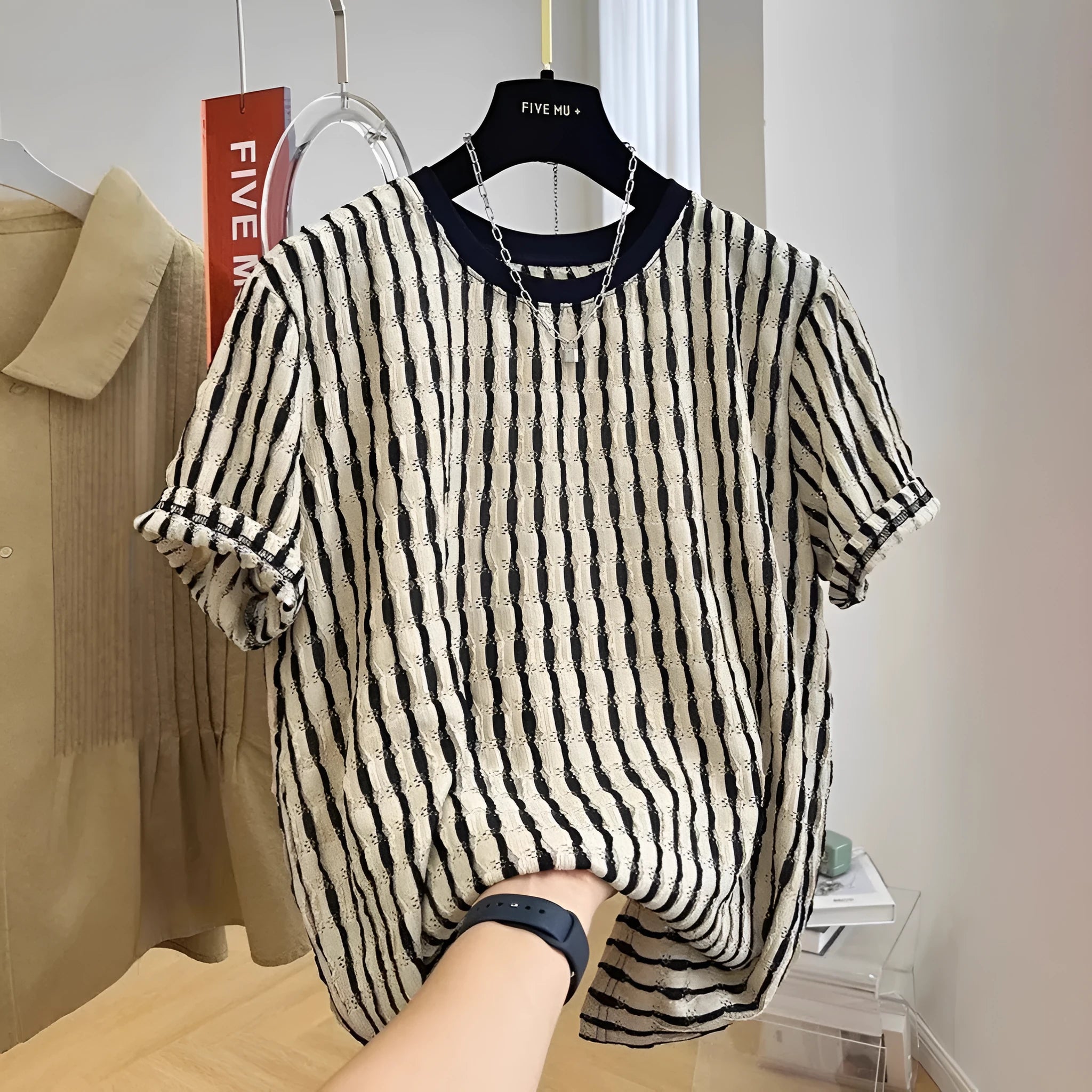 Black striped men's casual loose-fit short sleeve shirt made from a linen and silk blend fabric.