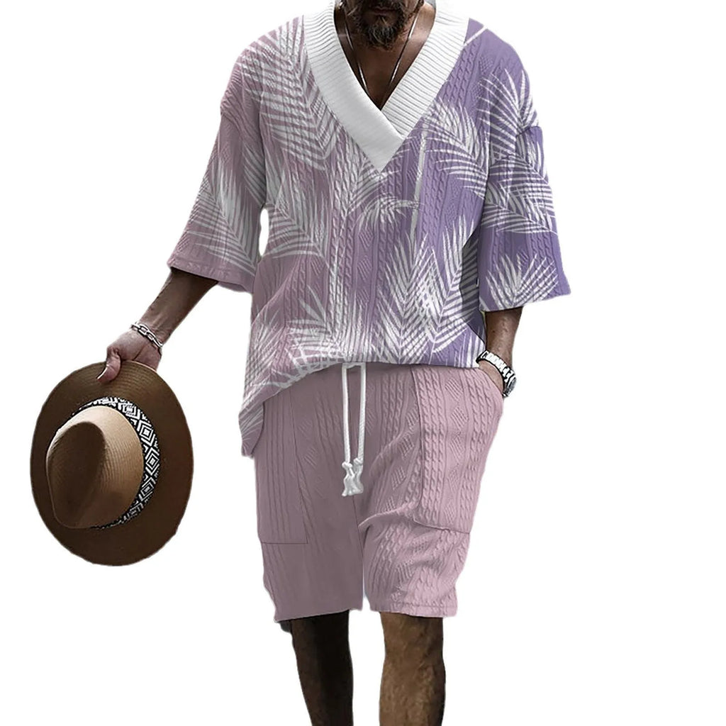 Man wearing a printed drop-shoulder knitted short-sleeved top with matching shorts in a casual setting.