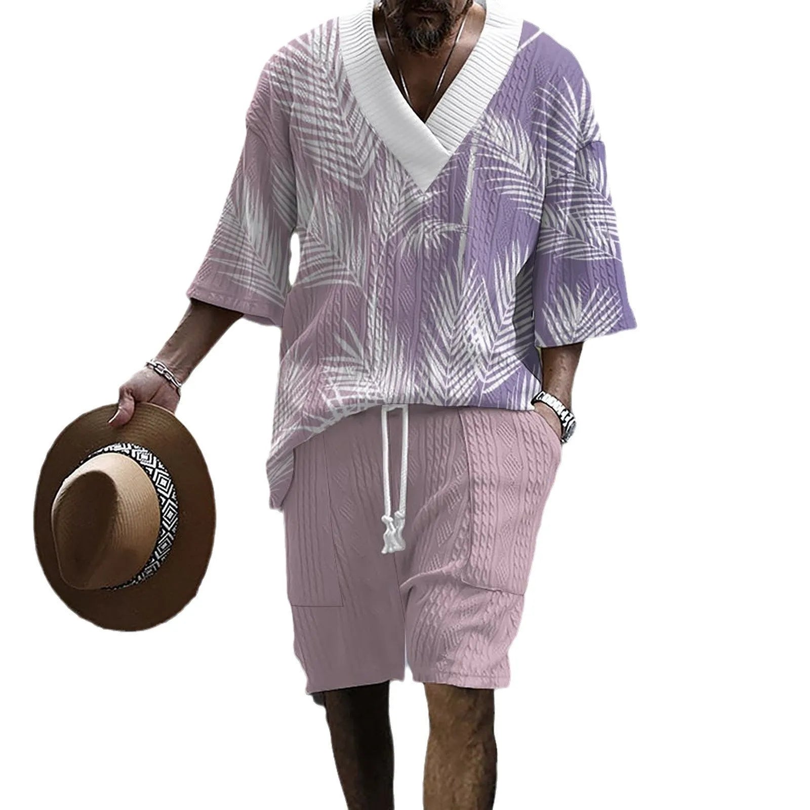 Man wearing a printed drop-shoulder knitted short-sleeved top with matching shorts in a casual setting.