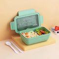Green four-layer partitioned plastic bento box showing compartment separation