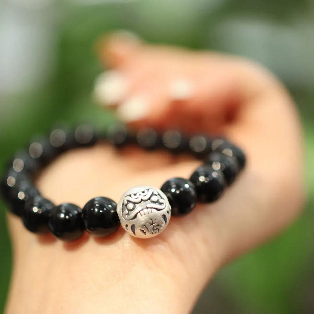 Women's black agate bracelet with sterling silver clasp showing 10mm stones and Chinese style design.