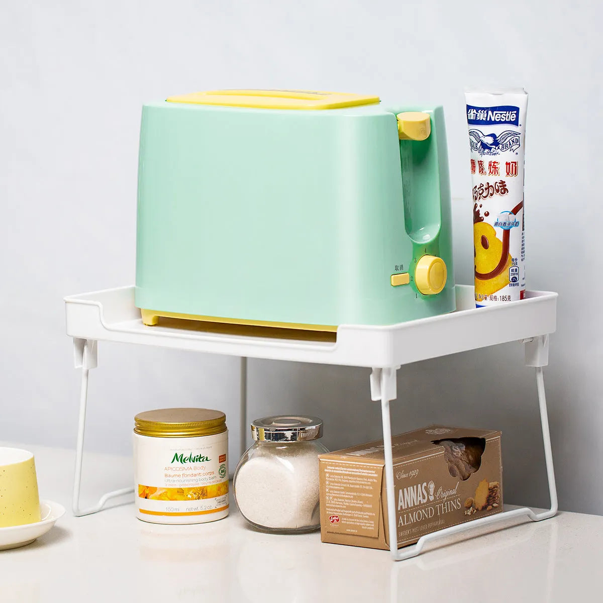 Plastic kitchen supplies rack on desktop, transparent finish, with assorted spice jars