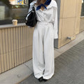 White striped wide-leg casual trousers with zipper closure on mannequin