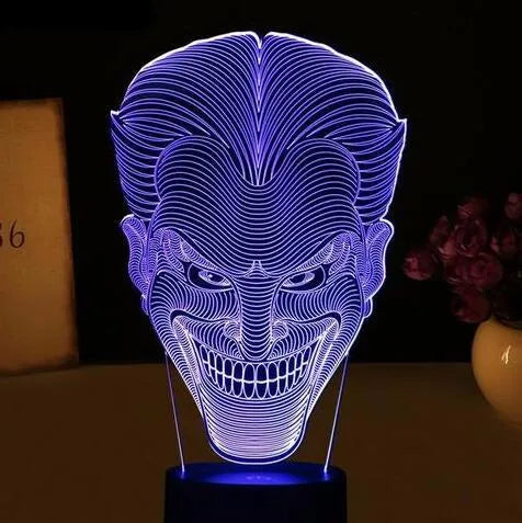 USB-powered 3D acrylic LED lamp showing colour gradient effect, with remote control and base on a desk.
