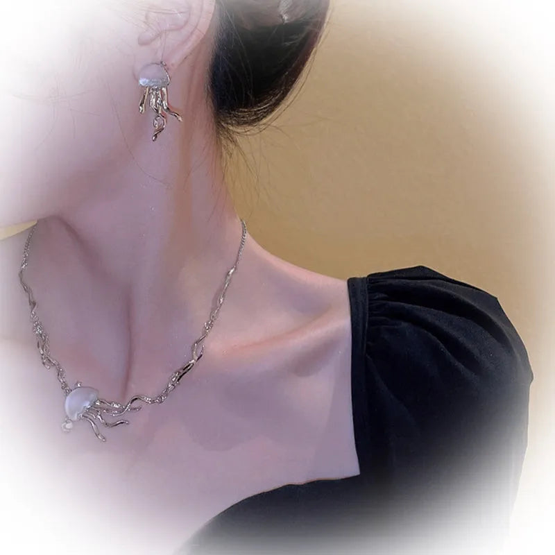 Frosted jellyfish pendant necklace and earrings in multiple colour options on a white background