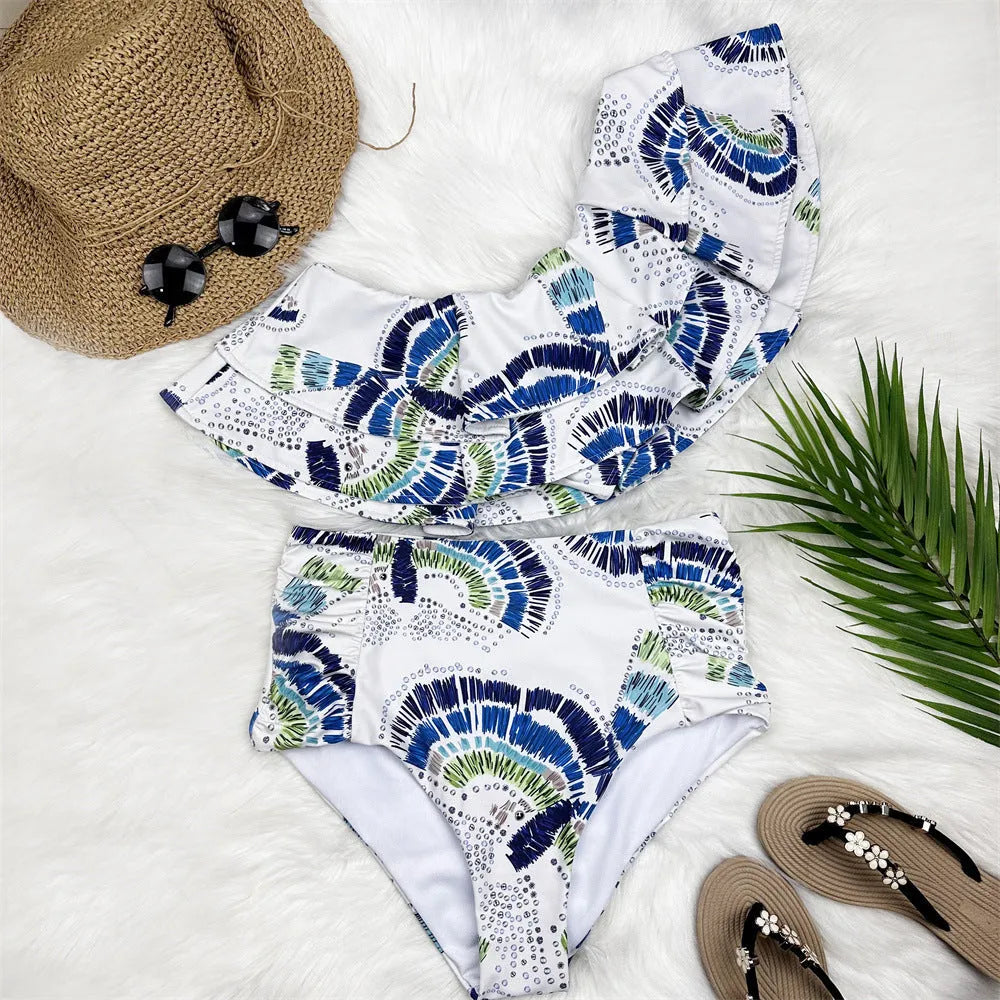 White women's one-shoulder swimsuit with large lotus leaf design and split bikini bottom