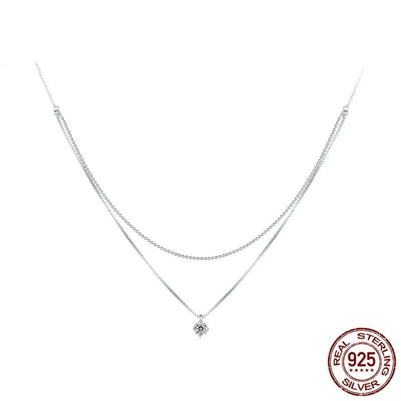 Silver double-layer necklace with pearl chain and sterling silver pendant.