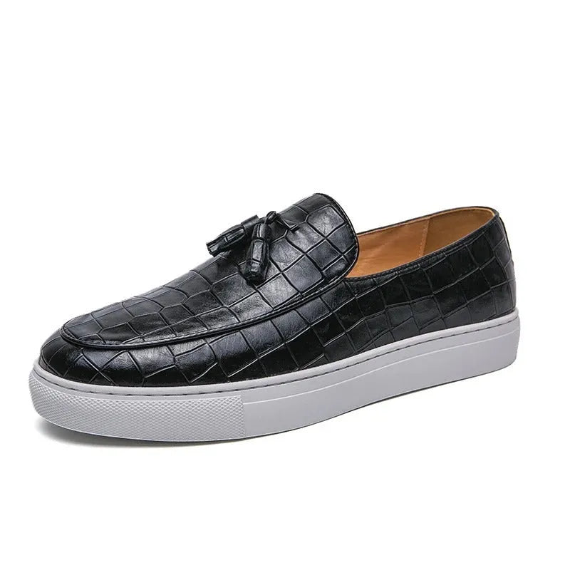 Men's black tassel detail leather-look sneakers on a white background, side view.