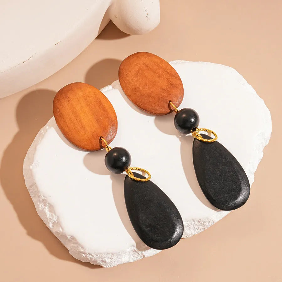 Handcrafted wooden retro earrings with elliptical design in silver brown black colours