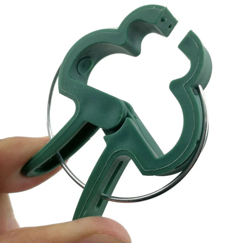 Green plastic and zinc plant fixing clips, large and small sizes, for climbing vegetable support.