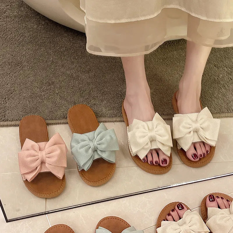 Women's slip-on suede sandals with bow detail, flat heel, rubber sole – beige colour option
