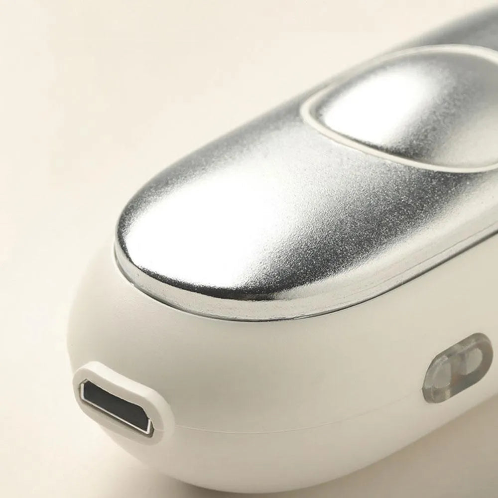 Hand-held micro-current sleep aid device with round button and stainless steel electrodes in grey colour
