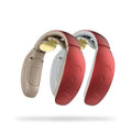Small portable red and white intelligent cervical massager device on table.