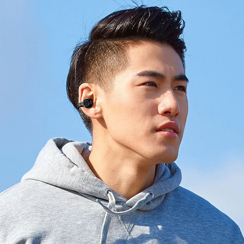Black wireless Bluetooth headset with clip-on design for bone conduction audio during exercise