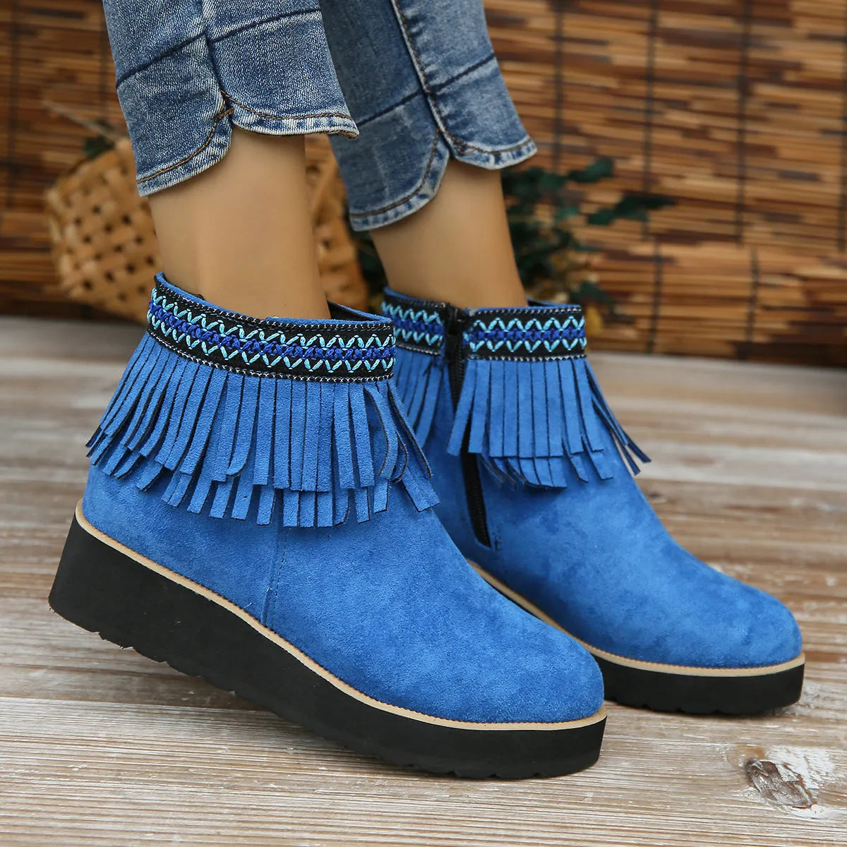 Women's suede wedge booties with side zipper, thick rubber sole, and tassel detail in black colour