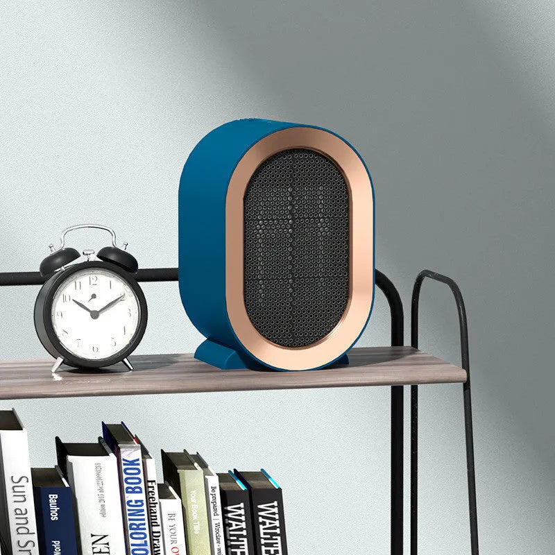 Black desktop electric mini fan heater with PTC ceramic heating on a table, 220V, for home office use