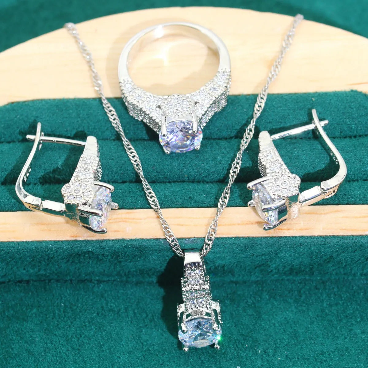 Bridal zircon jewellery four-piece set showing necklace, bracelet, earrings, and ring with water wave chain