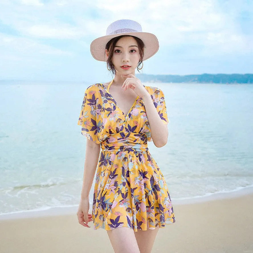 Women's yellow floral one-piece swimsuit with attached skirt, made from polyester, available in multiple sizes