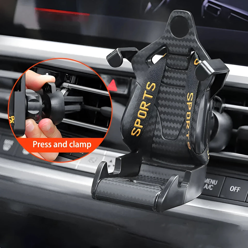 Racing seat shape car phone holder clipped to a car air vent with a gold tape colour finish
