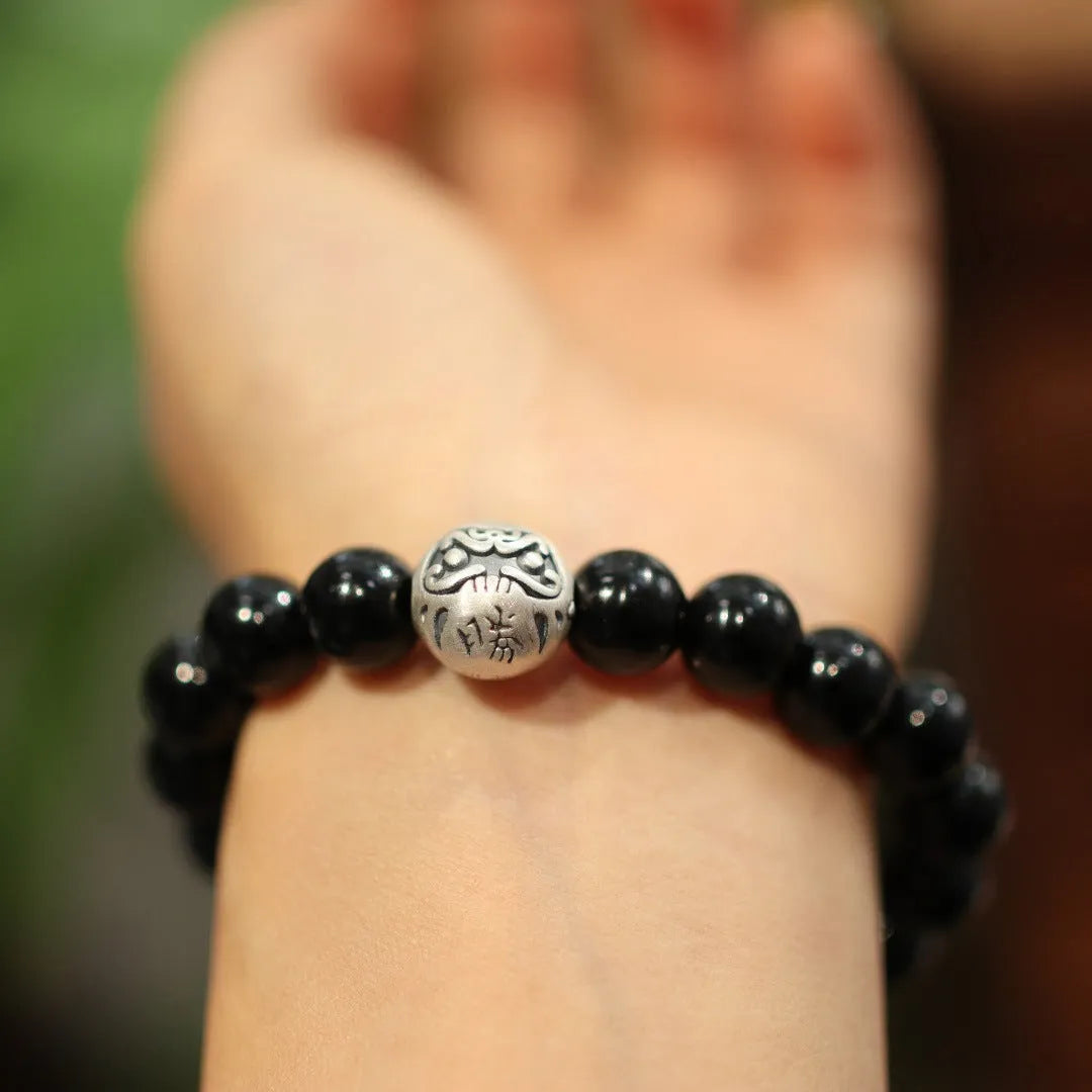 Women's black agate bracelet with sterling silver clasp showing 10mm stones and Chinese style design.