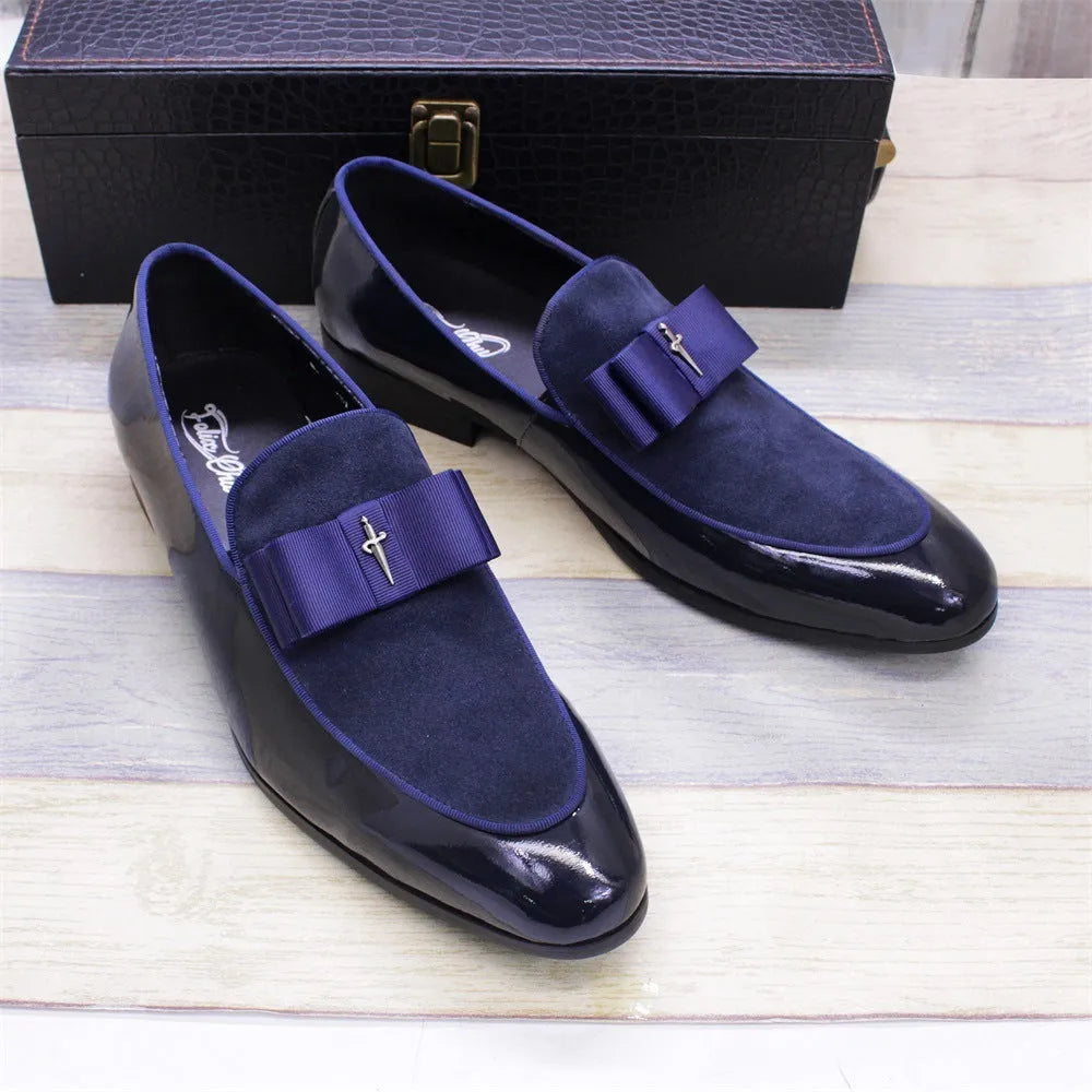 Men's black patent leather dress shoes with a gold tassel detail on the front.
