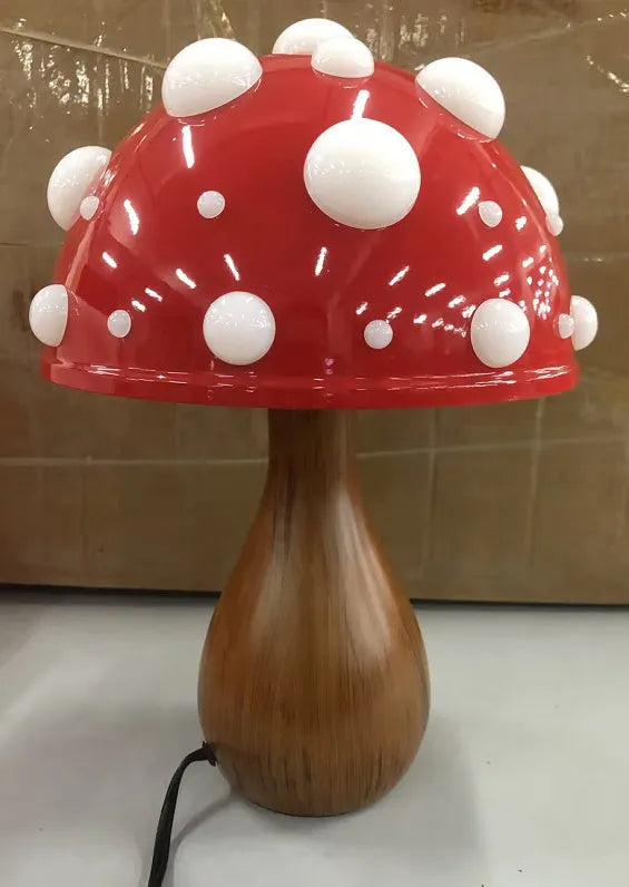 Mushroom decorative table lamp with white base and tricolour light on a wooden nightstand