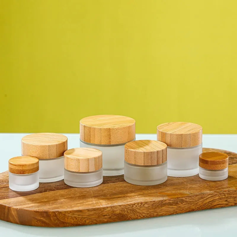 Glass sub-bottle with bamboo wood cover for travel cream in 50g size, transparent finish