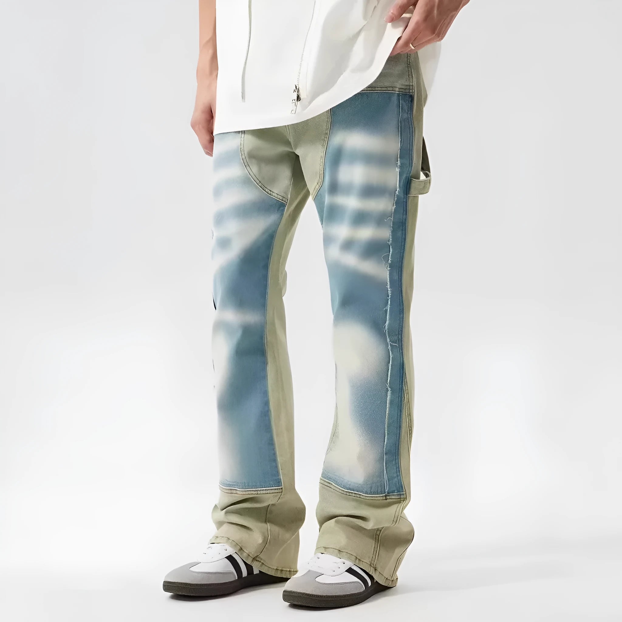Yellow and blue retro patchwork jeans with a splash-ink damaged design, shown on a mannequin.