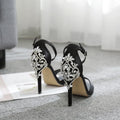 Black suede women's high heel shoes with rhinestone decoration and a peep toe.