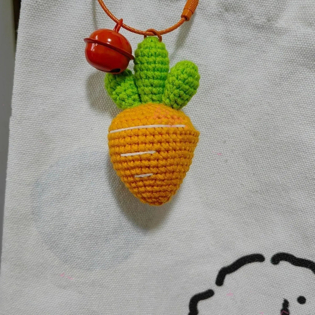 Orange and green carrot keychain pendant made from wool, shown on a key ring