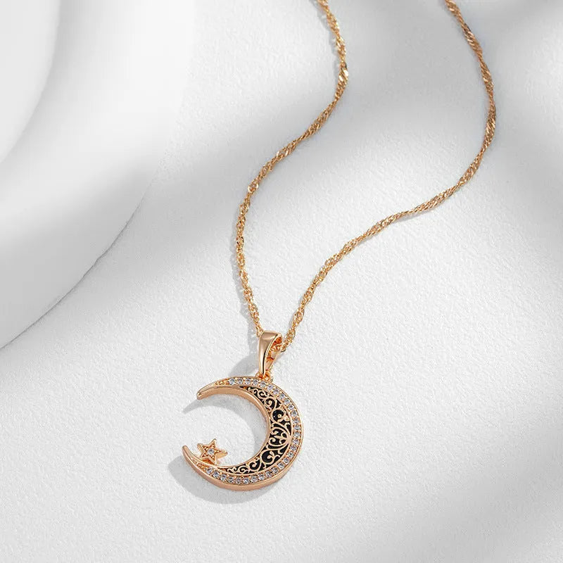 Rose gold star and moon necklace with zircon and enamel pendant on a water wave chain.