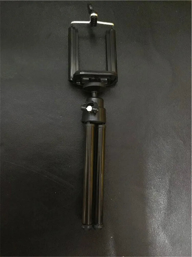 Black desktop phone holder with two-section adjustable bracket holding smartphone