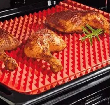 Red non-stick silicone pyramid cooking mat on a baking tray, showing grid pattern and 39.5 cm size