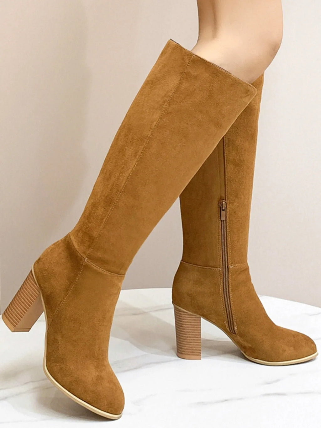 Women's black square toe high heel fashion boot made from artificial PU material.