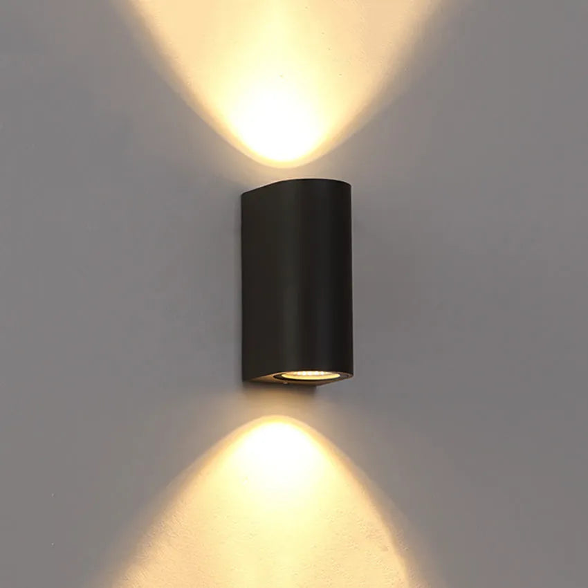 Modern aluminium and glass LED wall lamp in a black finish with silicone rubber trim.