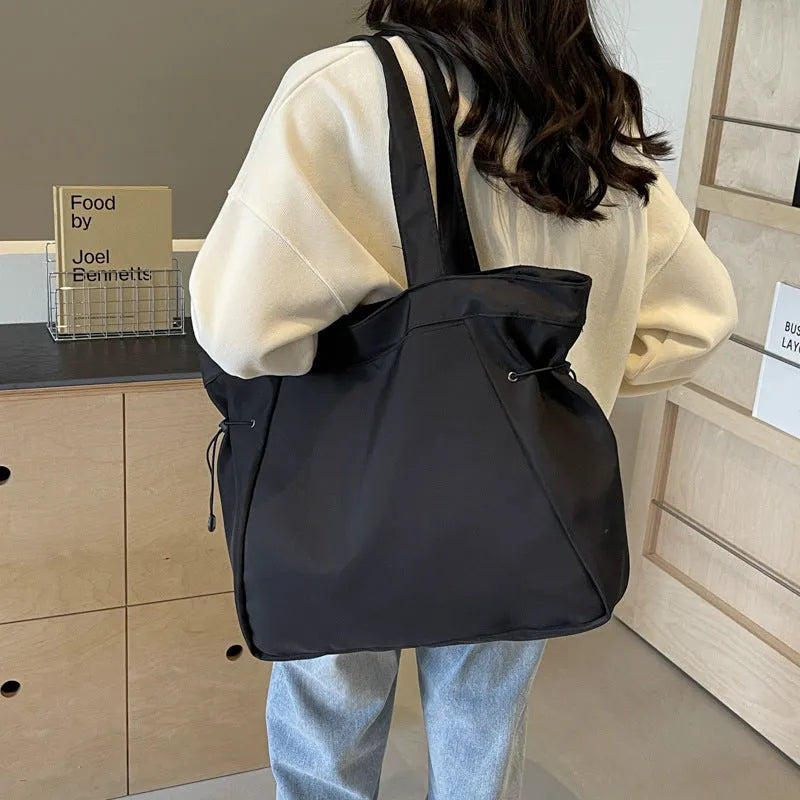 Soft folding Oxford cloth tote bag in a street style, shown in multiple colour options.