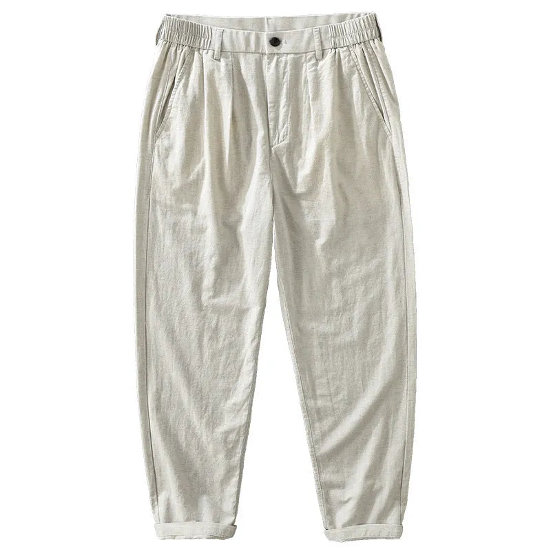 Men's loose straight cotton linen pants in raw jute colour, mid rise, zipper fly, side view on model