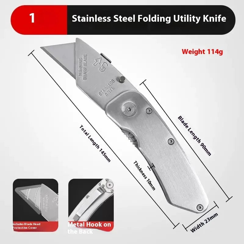 Stainless steel folding art knife with black blade, showing open position on work surface